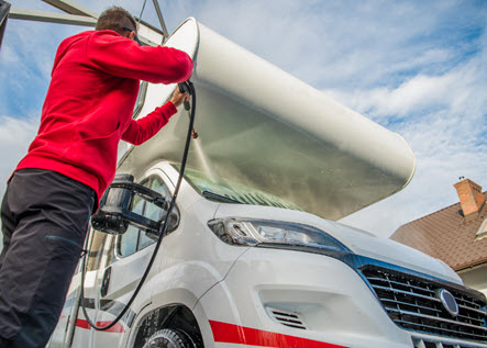 a person cleaning fibreglass parts on his motorhome