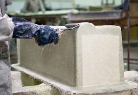 a person making a fibreglass moulding